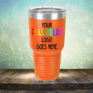 An orange insulated tumbler with a ribbed bottom sits on a wooden surface, featuring the text "Your Full Color Logo Goes Here" against a blurred, sparkling background. These customized Custom UV Printed Drinkware - Single Side Printing Included in Price are perfect for showcasing your brand.
