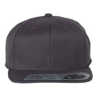 A front view of the Flexfit 110® Flat Bill Snapback Hat by Flexfit, featuring a structured six-panel design in plain dark gray with a flat brim and two ventilation holes on the front panels. Made from acrylic/wool/spandex, this hat also features a sticker on the brim and includes a snapback closure for adjustable comfort.