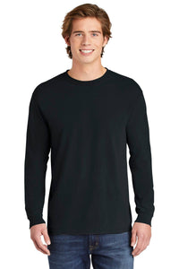 A young man faces forward, smiling against a white background, wearing blue jeans and a Comfort Colors Heavyweight Ring Spun Long Sleeve T-Shirt 6014 by Comfort Colors.