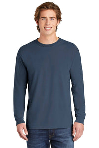 A young man stands facing forward and smiles at the camera, wearing jeans and a Comfort Colors Heavyweight Ring Spun Long Sleeve T-Shirt 6014 by Comfort Colors, against a white background.