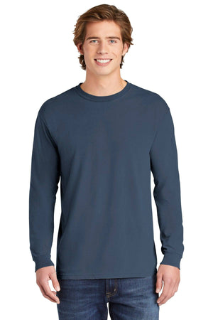 A young man stands facing forward and smiles at the camera, wearing jeans and a Comfort Colors Heavyweight Ring Spun Long Sleeve T-Shirt 6014 by Comfort Colors, against a white background.