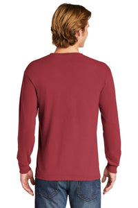 A person with light brown hair, shown from the back, wears a customized Comfort Colors Heavyweight Ring Spun Long Sleeve T-Shirt 6014 in red and blue jeans.