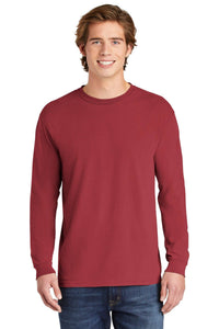 A young man faces forward in a plain maroon Comfort Colors Heavyweight Ring Spun Long Sleeve T-Shirt 6014 and blue jeans, set against a white background.