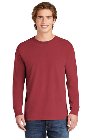 A young man faces forward in a plain maroon Comfort Colors Heavyweight Ring Spun Long Sleeve T-Shirt 6014 and blue jeans, set against a white background.