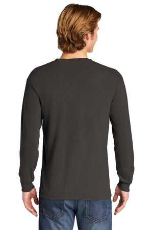 A person with light brown hair is standing and facing away, wearing a Comfort Colors Heavyweight Ring Spun Long Sleeve T-Shirt 6014 in black and blue jeans.