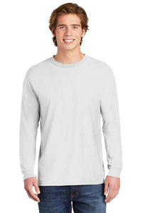 A young man stands facing forward and smiles, wearing blue jeans and a Comfort Colors Heavyweight Ring Spun Long Sleeve T-Shirt 6014 in plain white.