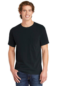 A young man with light brown hair smiles at the camera, wearing blue jeans and a black Comfort Colors Heavyweight Ring Spun Pocket T-Shirt (6030) featuring a chest pocket.