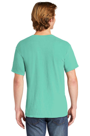 A person with light brown hair is seen from behind wearing a mint green Comfort Colors Heavyweight Ring Spun Pocket T-Shirt 6030 and blue jeans.