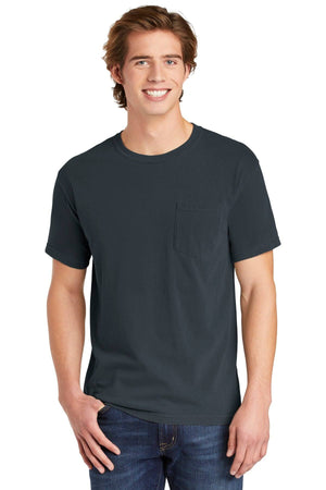 A young man smiles in a Comfort Colors Heavyweight Ring Spun Pocket T-Shirt 6030 and blue jeans, standing against a plain white background.