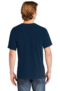 A person with light brown hair is seen from the back, wearing a Comfort Colors Heavyweight Ring Spun Pocket T-Shirt 6030 in navy and blue jeans against a white background.