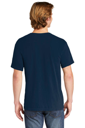 A person with light brown hair is seen from the back, wearing a Comfort Colors Heavyweight Ring Spun Pocket T-Shirt 6030 in navy and blue jeans against a white background.
