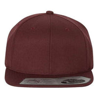 The Flexfit 110® Flat Bill Snapback Hat by Flexfit is a maroon-colored, structured six-panel baseball cap featuring a flat brim and an adjustable snapback closure, complete with a sticker on it for authenticity.