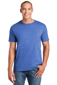 Wearing a Gildan Softstyle T-Shirt 64000 in blue, made of ring spun cotton, and jeans, a person smiles against a white background.