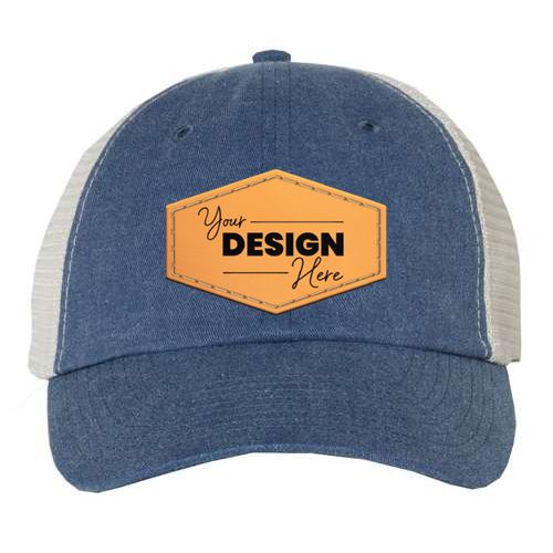 The Sportsman Pigment-Dyed Snapback Trucker Hat by Sportsman is a custom embroidered hat in a blue and white mesh design. It features a low-profile construction with an orange hexagonal patch on the front, displaying the text "Your Design Here." Made from a cotton/polyester blend, it includes a plastic tab closure for an adjustable fit.