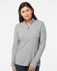 A woman wearing an Adidas Women's Lightweight Melange Quarter-Zip Pullover in grey.