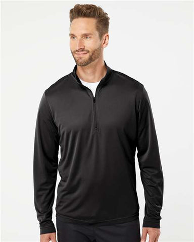 A man with short, styled hair is wearing an Adidas Lightweight Quarter-Zip Pullover in black over a white undershirt, posing against a plain white background.