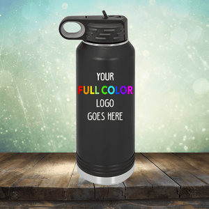A black Custom UV Printed Drinkware - Single Side Printing Included in Price from Kodiak Coolers with a handle on the lid is displayed on a wooden surface with a sparkly background. The text on the bottle reads "YOUR FULL COLOR LOGO GOES HERE." This versatile piece pairs perfectly with customized tumblers and personalized coffee mugs for a complete, branded set.