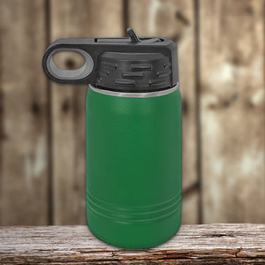 Kodiak Coolers Green vacuum-sealed insulation technology water bottle with a black lid on a wooden surface against a blurred wooden background.