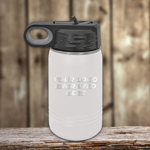 A white Kodiak Coolers water bottle with a black lid and loop handle sits on a wooden surface, perfect for showcasing your laser-engraved logo. Ideal for custom tumblers, it exemplifies the elegance possible with the $250 minimal order in our Presidents Day sale—no setup fee included.