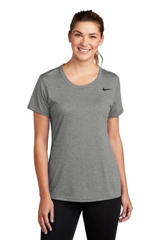 Woman wearing a grey Nike Ladies Legend T-Shirt CU7599, crafted with Dri-FIT technology and smiling.