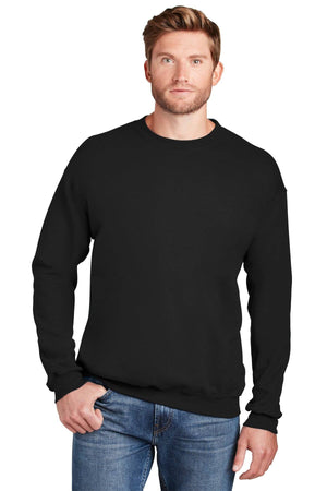 A man stands facing forward against a white background with one hand in his pocket, wearing blue jeans and a Hanes Ultimate 100% Cotton Crewneck Sweatshirt F260 in plain black.