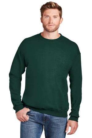 A man with light brown hair wearing a dark green Hanes Ultimate 100% Cotton Crewneck Sweatshirt F260 and blue jeans stands against a white background.