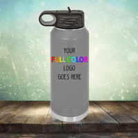 Gray Custom UV Printed Drinkware - Single Side Printing Included in Price from Kodiak Coolers with a black lid and a space for a full-color logo with the text "YOUR FULL COLOR LOGO GOES HERE" on a wooden surface against a blurred background. Perfect next to your personalized coffee mugs or customized tumblers.