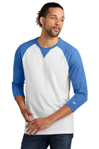 A person wears the New Era Cotton Blend 3/4-Sleeve Baseball Raglan T-Shirt NEA121 in white and blue, made from a sueded cotton blend, looking to the side with a neutral expression.