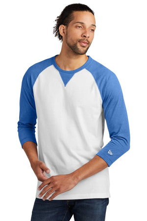 A person wears the New Era Cotton Blend 3/4-Sleeve Baseball Raglan T-Shirt NEA121 in white and blue, made from a sueded cotton blend, looking to the side with a neutral expression.