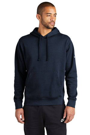 A man in a dark Nike Club Fleece Sleeve Swoosh Pullover Hoodie Sweatshirt (NKDR1499), paired with sweatpants adorned with a small logo, stands confidently against a white background, embodying the casual street-ready look.