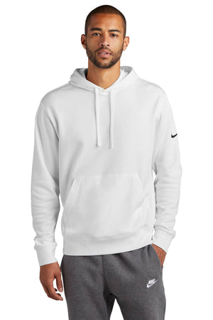 A person wearing a Nike Club Fleece Sleeve Swoosh Pullover Hoodie Sweatshirt NKDR1499 and gray sweatpants stands against a white background, showcasing a casual street-ready look.