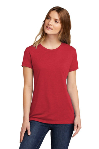 A person in a Next Level Apparel Women's CVC T-Shirt NL6610, made of combed ring-spun cotton, and blue jeans stands against a white background.
