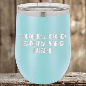 The Kodiak Coolers "Realtor Closing Gifts for Clients" tumbler features light blue stainless steel with a silver lid, displayed on wood. Bold white text reads "YOUR LOGO ENGRAVED HERE," perfect as custom promotional drinkware.