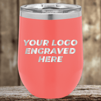 A pink insulated tumbler by Kodiak Coolers, engraved with your custom company logo, perfect as a realtor closing gift for clients. Features a clear lid and is ideal promotional drinkware, shown on wood with a blurred background.