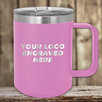 On a wooden surface sits the pink 15 oz insulated coffee mug by Kodiak Coolers, ideal for promotional gifts. With "YOUR LOGO ENGRAVED HERE," it shows how brands can have personalized mugs, including an engraved logo sample and setup fee.