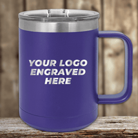 A Kodiak Coolers 15 oz insulated coffee mug with a handle, featuring "YOUR LOGO ENGRAVED HERE," sits on a wooden surface. Perfect as a personalized or promotional gift, it includes a lid to keep drinks hot. The background is an elegantly blurred wooden texture.