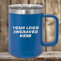 The Kodiak Coolers SAMPLE - 15 oz insulated coffee mug with handle features "YOUR LOGO ENGRAVED HERE" and a clear lid, perfect as a promotional gift. It sits on a wooden surface against a blurred wooden background.