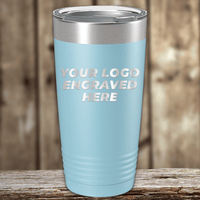A light blue metal tumbler by Kodiak Coolers with your custom company logo engraved, showcased on a wooden surface—ideal as a unique Realtor closing gift for clients.