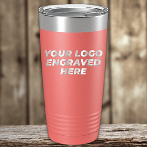 A pink stainless steel tumbler by Kodiak Coolers, engraved with your custom company logo, sits on a wooden surface—ideal as a Realtor closing gift for clients.