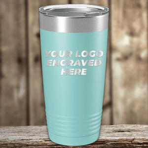 A teal Kodiak Coolers tumbler with your custom company logo engraved, shown on a wooden surface—ideal as a personalized Realtor closing gift or unique promotional drinkware for clients.