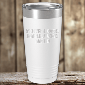 A white insulated tumbler from Kodiak Coolers with a metal lid rests on a wooden surface. "YOUR LOGO ENGRAVED HERE" is printed, making it ideal as a Realtor Closing Gift for Clients with your custom company logo.