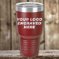 A red insulated tumbler from Kodiak Coolers with your custom company logo engraved sits on a wooden surface, making it the perfect Realtor closing gift for clients or a standout addition to your personalized drinkware collection.
