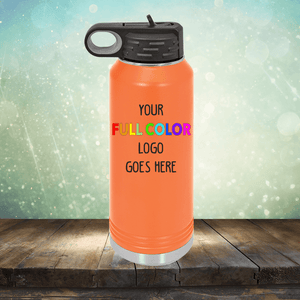 Orange Custom UV Printed Drinkware - ONE TIME SPECIAL OFFER by Kodiak Coolers on a wooden surface with the text "YOUR FULL COLOR LOGO GOES HERE" printed on it. Background features a sparkling, bokeh effect, reminiscent of stylish tumblers and coffee mugs often found in upscale cafes.