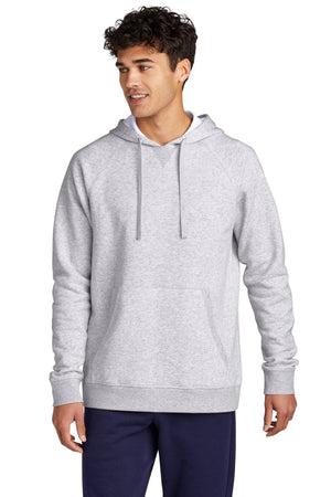 A person is wearing a Sport-Tek Drive Fleece Pullover Hoodie Sweatshirt STF200 in gray, paired with dark pants, standing against a white background. The cotton-rich fleece from Sport-Tek offers both comfort and style.