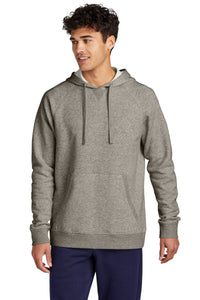 A person is wearing a Sport-Tek Drive Fleece Pullover Hoodie Sweatshirt STF200 in gray and dark pants, standing against a plain white background.