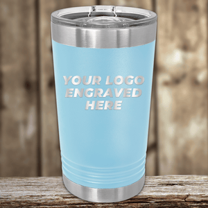 A Kodiak Coolers light blue insulated tumbler with silver lid and rim, custom engraved with your company logo—ideal as a realtor closing gift for clients. "YOUR LOGO ENGRAVED HERE" is shown on the front.