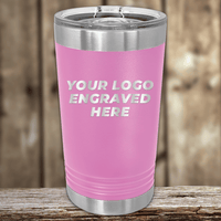 A pink stainless steel tumbler by Kodiak Coolers with a clear lid and your custom company logo engraved sits on a wooden surface—perfect as a Realtor closing gift and stylish promotional drinkware for showcasing your brand.
