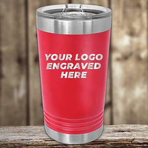 A red Kodiak Coolers tumbler with a clear lid rests on wood, engraved with "YOUR LOGO ENGRAVED HERE" in white—ideal as a Realtor Closing Gift featuring your custom company logo on drinkware for clients.