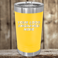 A yellow Kodiak Coolers tumbler with metal lid and trim, engraved with your custom company logo—ideal as a Realtor closing gift—rests on a wooden surface against a blurred wood background.