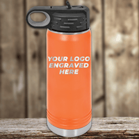 A Kodiak Coolers orange insulated water bottle with a black lid sits on a wooden surface, featuring your custom company logo engraved—an ideal Realtor closing gift and standout piece of branded drinkware for clients.